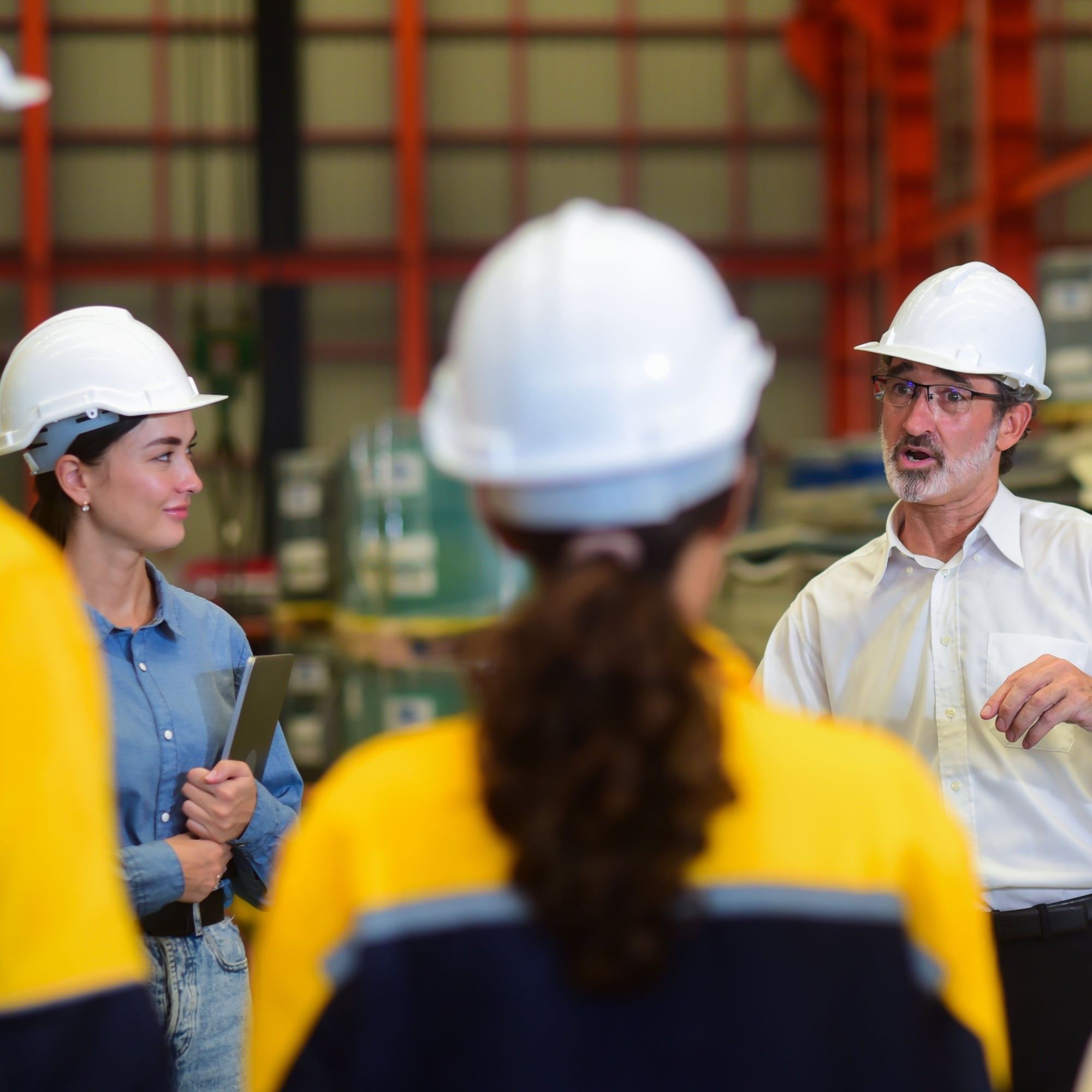 manager wearing safety hardhat, training industry worker.